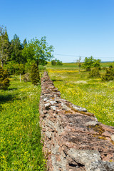 Sticker - Long Limestone stone wall on a flowering summer meadow