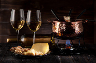 swiss cheese fondue on rustic background