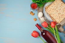 Passover Holiday Concept Seder Plate, Matzoh And Tulip Flowers On Wooden Background. Top View From Above