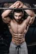 © antondotsenko - Handsome fitness model train in the gym gain muscle.