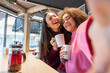 © Davide Angelini - Multiracial best friends taking a selfie at the bar