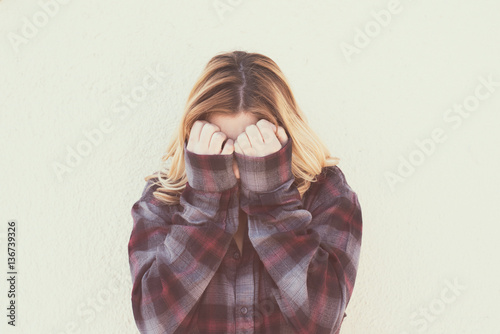 Fotografía Young woman with hands over face in retro style portrait