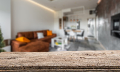 Wooden board empty table in front of blurred background. Perspective light wood over blur in living room interior- can be used for display or montage your products. Mock up for display of product