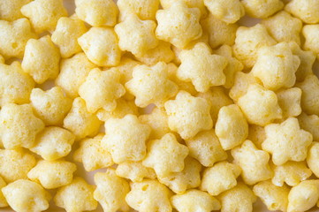 Salty star shaped snacks background pattern