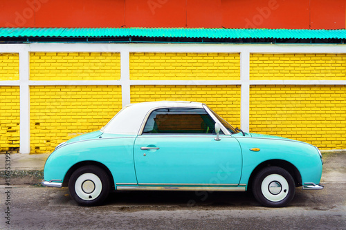 Fotografering Side view of classic car parked on street in city - vintage retro color effect s