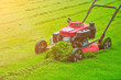 Lawn mower cutting green grass in backyard,Garden service,grass cutter cutting green lawns.