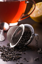 Tea Strainer With A Cup On Dark Background