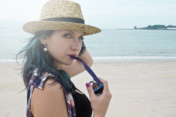 girl with hat of straw in the beach