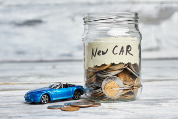 Toy car, money and card. Savings for buying new car.