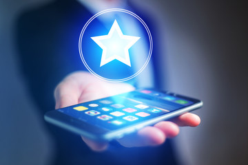 Poster - Businessman hand holding mobile phone with staricon