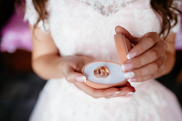 the bride holding a box with wedding rings