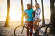 © Joshua Resnick - active couple taking time to relax after riding bikes on the beach at santa monica california