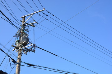 electricity transmission pylon against blue sky