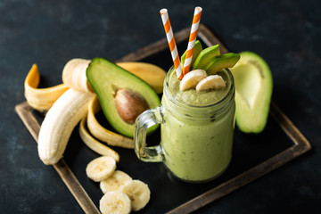 Wall Mural - Fresh blended Banana and avocado smoothie with yogurt or milk in mason jar, healthy eating, superfood