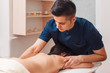 Young man treating womans back at office. Male masseur massaging nude woman, free space. Alternative medicine, weight loss, body care, spa, masterclass, beauty salon,resort concept