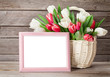 Colorful tulips bouquet and photo frame