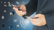 © pairhandmade - Businessman is using mobile phone and holding card on another ha