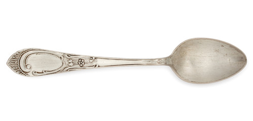 Vintage silverware, old decorated spoon isolated on a white, top