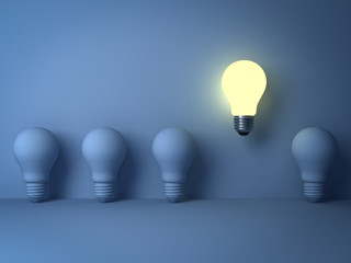 Aufkleber - One glowing light bulb standing out from the unlit incandescent bulbs on blue background with shadow The business concept and individuality concept 3D rendering