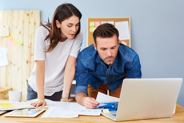 Sticker - Couple working together at small office with laptop and documents