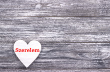 Decorative White Wooden Heart On Grey Wooden Background With Lettering Love Italian.