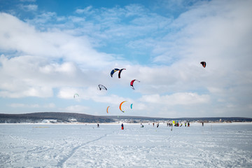 snow kiting on a snowboard on a frozen lake