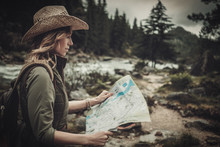 Woman Hiker, Searching Right Direction On Map Near Wild Mountain River.