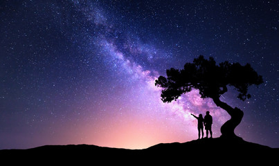 Wall Mural - milky way with people under the tree on the hill. landscape with night starry sky and silhouette of 