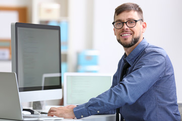 Sticker - Handsome young programmer working in office