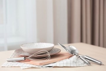 Canvas Print - Set of metal kitchen utensils with dishes on table