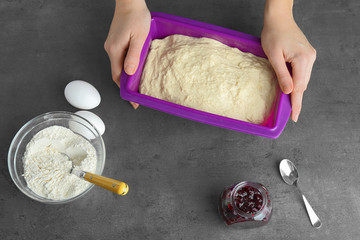 Wall Mural - Female hands preparing cake on kitchen table