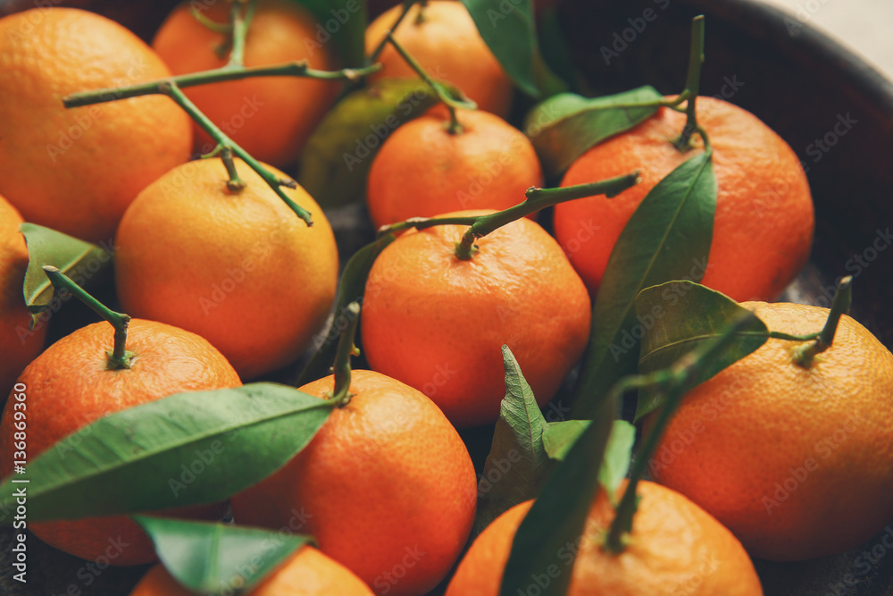 Juicy tangerines in bowl, closeup