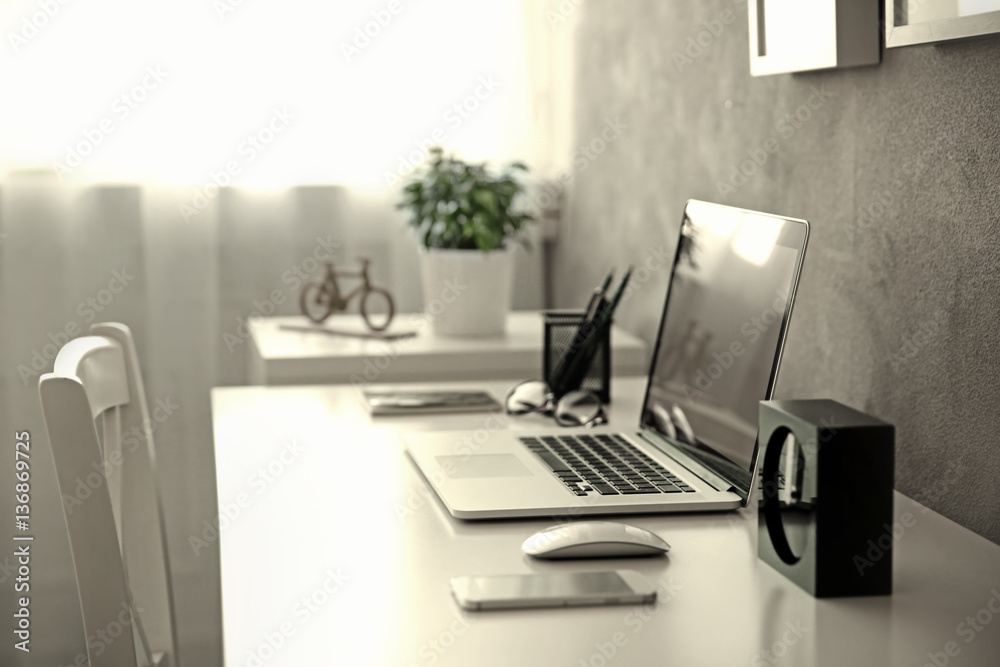Modern workplace with laptop on table