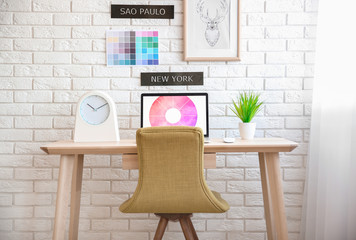 Wall Mural - Modern workplace with laptop and plant on table