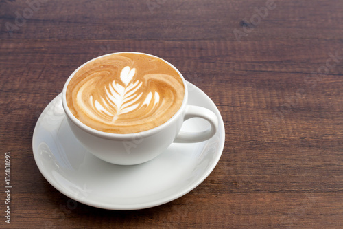 Fotografie, Obraz Coffee cup of rosetta latte art on wooden background with copy s
