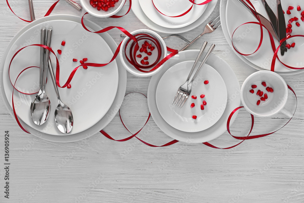 Cutlery set with plates on white wooden table