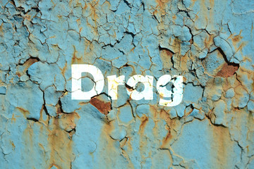 Sticker - drag word print on the green rusty metal painted background, grunge texture.