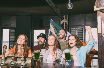 Wall Mural - People celebrating Saint Patrick's Day in pub