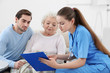 © Africa Studio - Nurse talking with grandmother and her grandson indoors