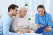 © Africa Studio - Nurse talking with grandmother and her grandson indoors