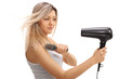 © Ljupco Smokovski - Pretty young woman using a hairbrush and a hairdryer