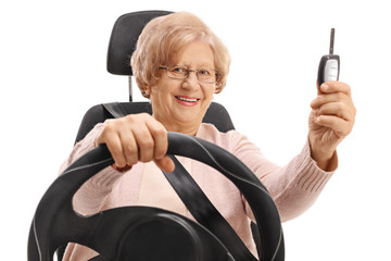 Canvas Print - Mature woman sitting in car seat and holding car key