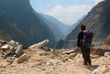Lonely Hiker Looks At One Of The Deepest Ravines Of The World, Tiger Leaping Gorge In Yunnan, Southern China
