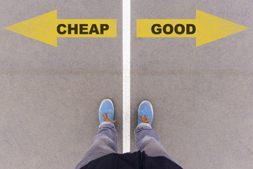 Wall Mural - cheap vs good text arrows on asphalt ground, feet and shoes on f