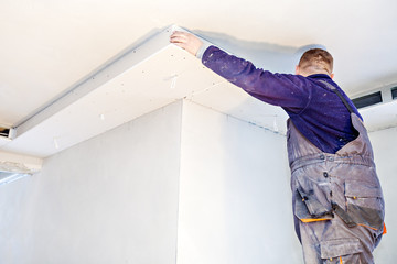 Wall Mural - Construction worker imposes a finishing coat on fire. Finishing the fireplace. Putting plaster.