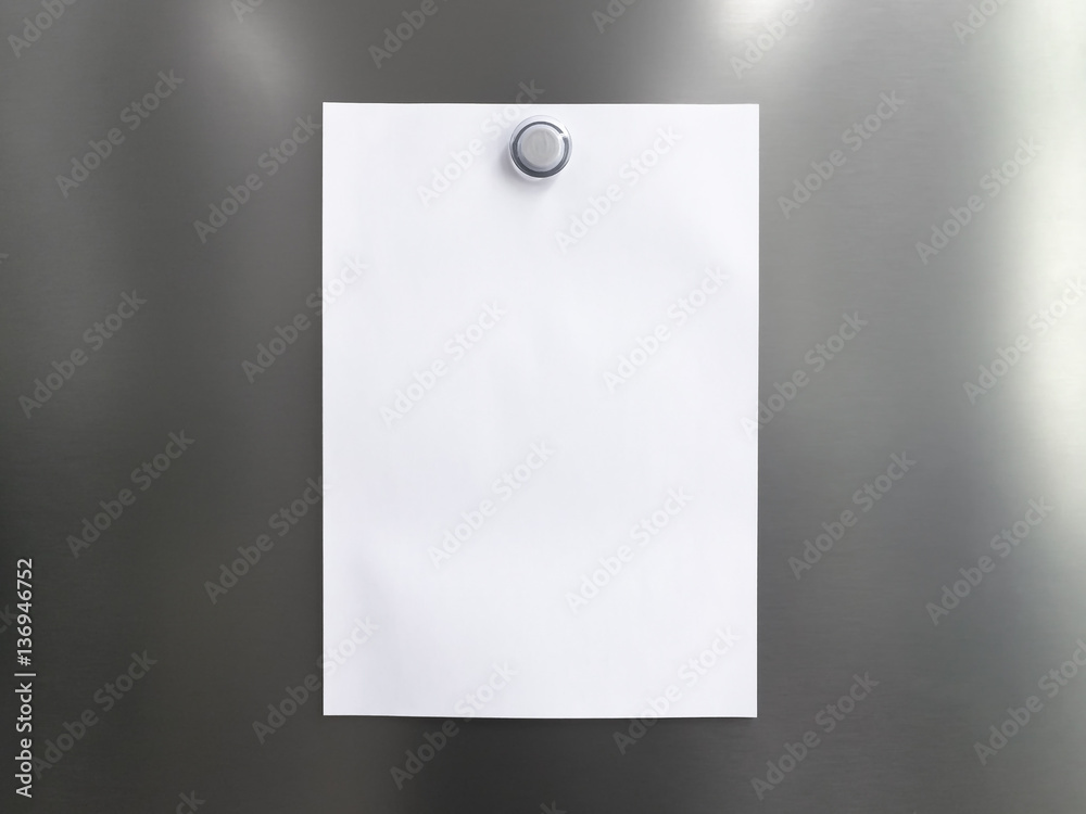 Blank white note paper with magnet clip on metal fridge / refrigerator door for reminder Stock Photo