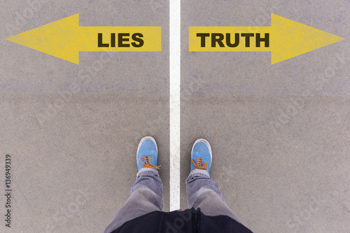 Fotomural Lies vs truth text arrows on asphalt ground, feet and shoes on f