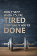 © dmshpak - metal barbell on dark gray background and motivation text