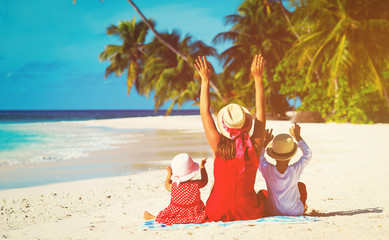 happy mother with two kids on tropical beach