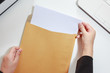 Businesswoman hands holding the blank paper in envelope - business
